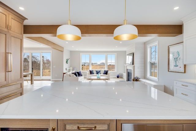 179 Beebe Acres Rd, Falmouth, MA 02540 - kitchen with light stone countertops, open floor plan, a fireplace, and recessed lighting