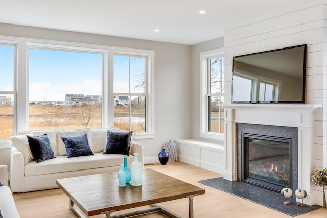179 Beebe Acres Rd, Falmouth, MA 02540 - living area with light wood-type flooring, baseboards, a glass covered fireplace, and recessed lighting