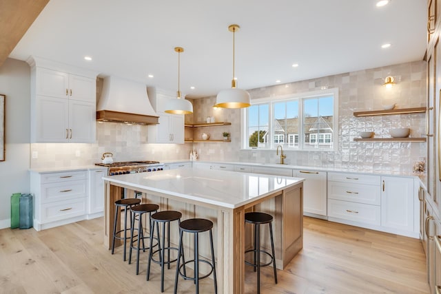 179 Beebe Acres Rd, Falmouth, MA 02540 - kitchen featuring open shelves, decorative backsplash, a breakfast bar area, and premium range hood