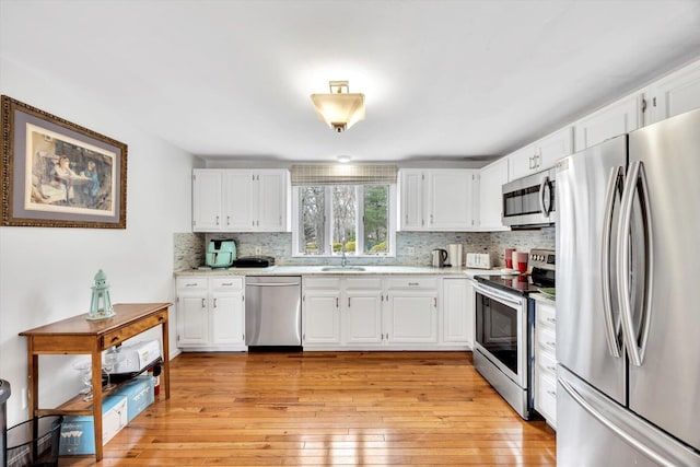 11 Elizabeth Ln, West Yarmouth, MA 02673 - kitchen with stainless steel appliances, tasteful backsplash, and white cabinets