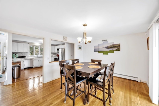 11 Elizabeth Ln, West Yarmouth, MA 02673 - dining space with a chandelier, light wood-style flooring, a baseboard heating unit, and baseboards