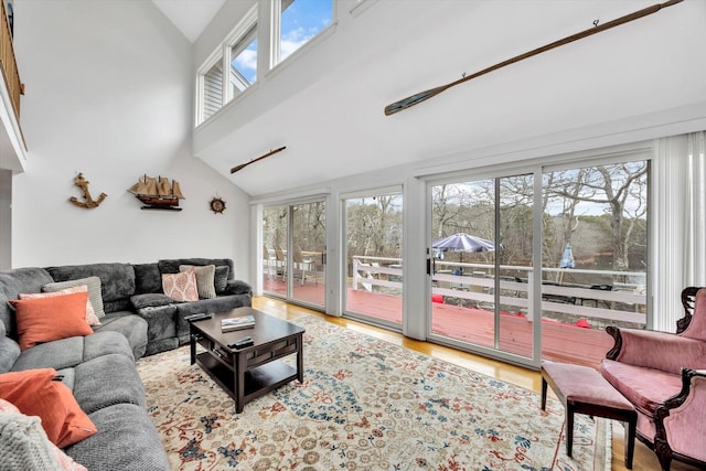 11 Elizabeth Ln, West Yarmouth, MA 02673 - living room featuring a wealth of natural light, high vaulted ceiling, and wood finished floors