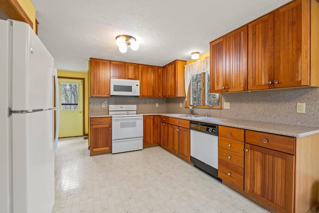 130 Surrey Ln, Brewster, MA 02631 - kitchen featuring brown cabinets, a sink, white appliances, and light countertops