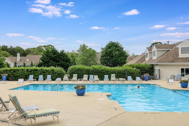 pool with fence and a patio