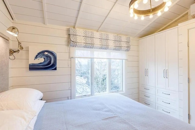 bedroom with wooden walls and lofted ceiling