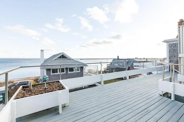 wooden deck featuring a water view