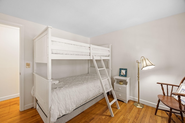 bedroom featuring wood finished floors and baseboards