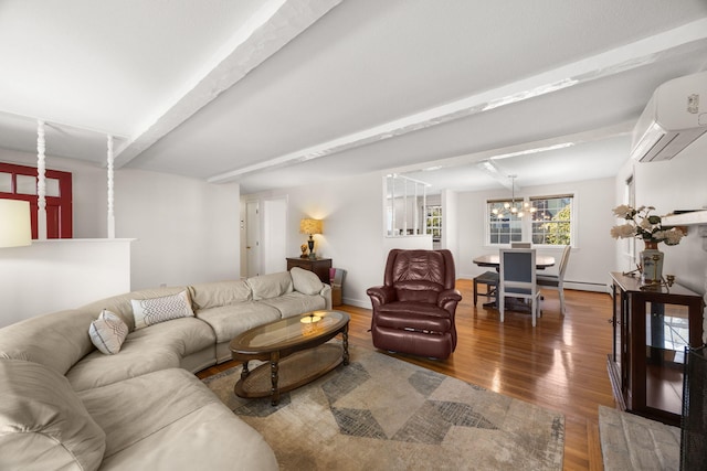 living room with a wall unit AC, an inviting chandelier, beam ceiling, and wood finished floors