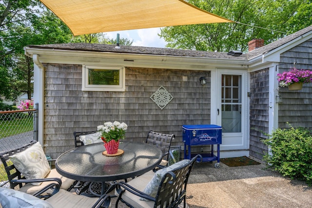 view of patio / terrace featuring fence and outdoor dining area