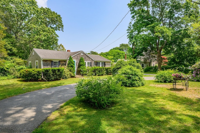 view of front of property with a chimney and a front yard