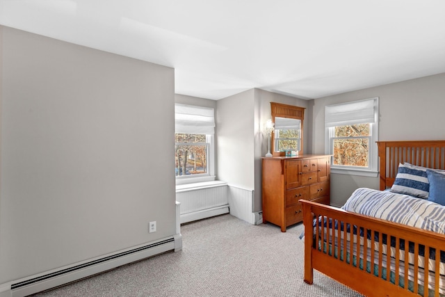 bedroom featuring light carpet and a baseboard radiator