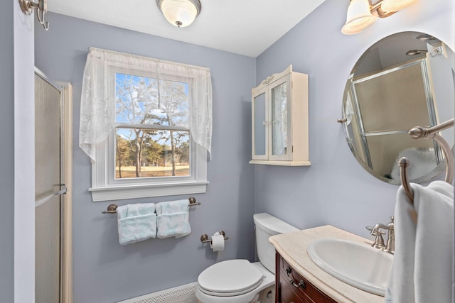 bathroom with baseboard heating, a shower with door, vanity, and toilet