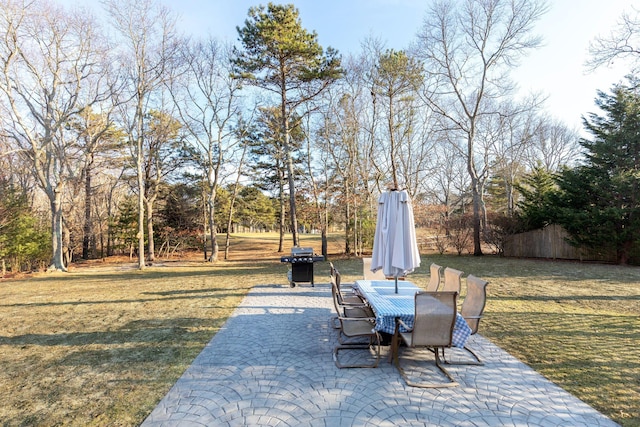 view of patio featuring fence, area for grilling, and outdoor dining space