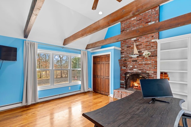 unfurnished office featuring ceiling fan, wood finished floors, vaulted ceiling with beams, a fireplace, and recessed lighting