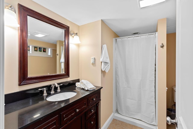 bathroom featuring curtained shower, tile patterned flooring, and vanity