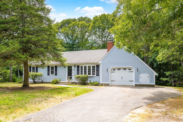 66 Chuckles Way, Marstons Mills, MA 02648 - view of front of property with a chimney, asphalt driveway, and an attached garage