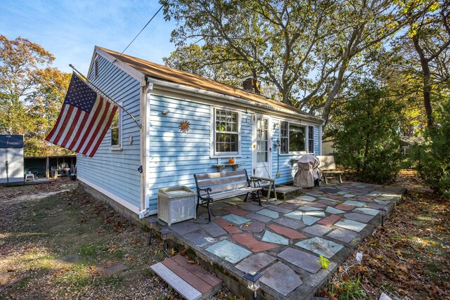 back of house with a patio