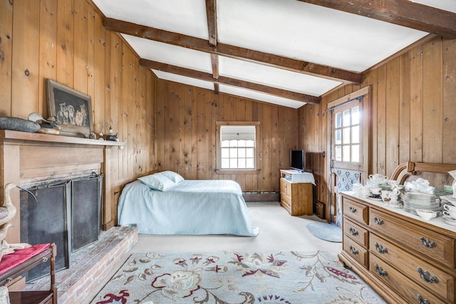 bedroom with a brick fireplace, light colored carpet, vaulted ceiling with beams, and multiple windows