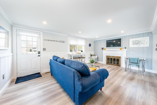 living room featuring ornamental molding and light hardwood / wood-style floors