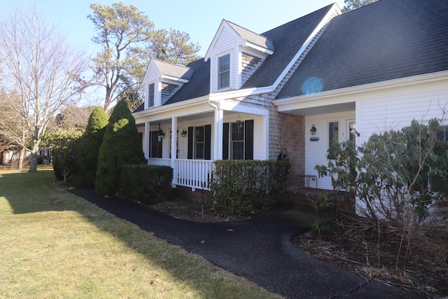 view of front of house with a porch and a front yard