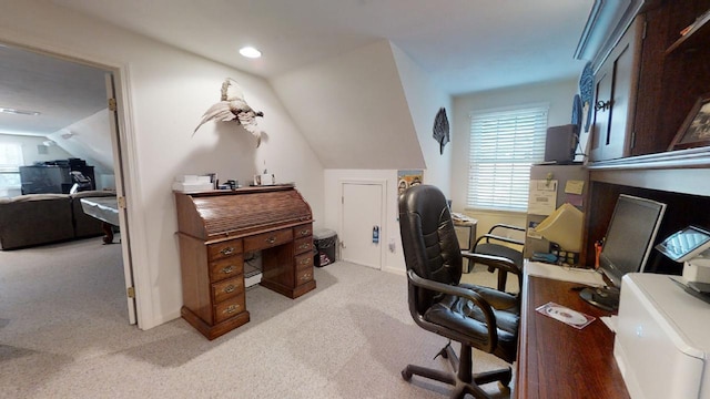 carpeted office space featuring lofted ceiling