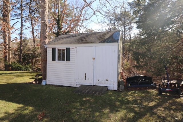 view of outbuilding featuring a lawn