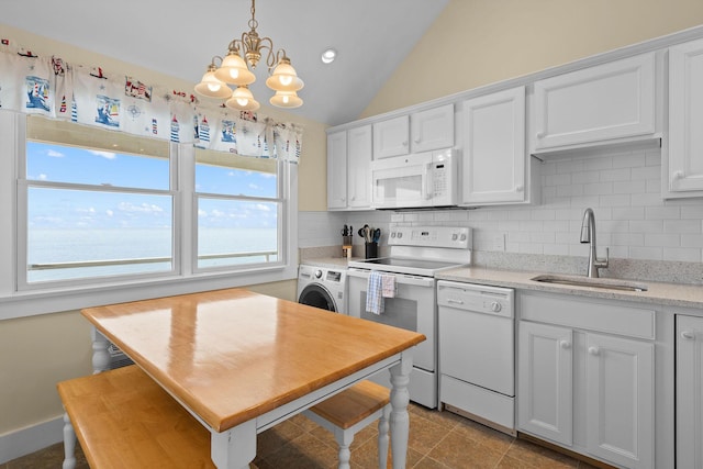 496 Shore Rd Unit 16, Truro, MA 02666 - kitchen featuring white appliances, backsplash, washer / dryer, and a sink