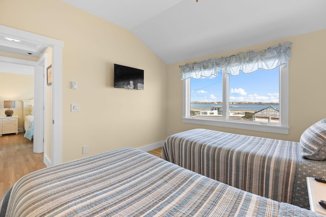 496 Shore Rd Unit 16, Truro, MA 02666 - bedroom featuring baseboards, vaulted ceiling, and light wood finished floors