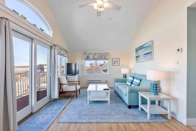 living room featuring ceiling fan, radiator, high vaulted ceiling, and light hardwood / wood-style flooring