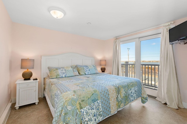 bedroom featuring a baseboard heating unit and access to outside