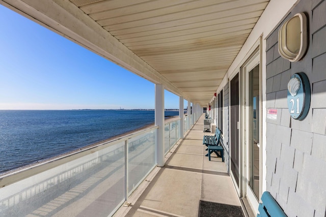 balcony featuring a water view and a view of the beach