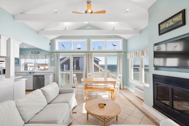 living room featuring sink, a wall mounted AC, lofted ceiling with beams, and light tile patterned floors