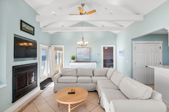 tiled living room with vaulted ceiling with beams and ceiling fan with notable chandelier