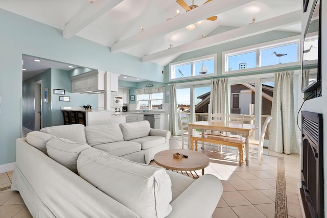 tiled living room featuring sink, beam ceiling, and high vaulted ceiling