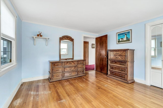 bedroom with light hardwood / wood-style floors and ornamental molding