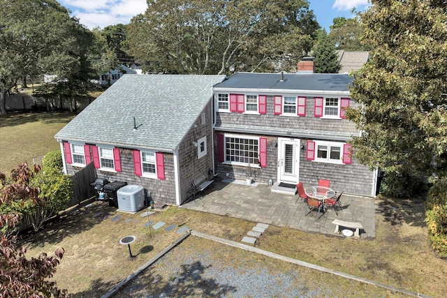 view of front of house featuring a patio and a front lawn