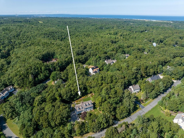 bird's eye view with a wooded view