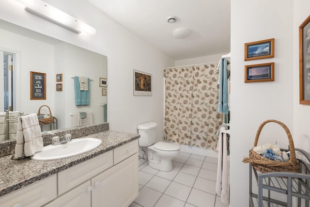 bathroom featuring tile patterned flooring, vanity, walk in shower, and toilet