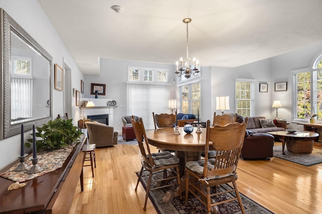 dining area featuring plenty of natural light, light hardwood / wood-style floors, and a chandelier