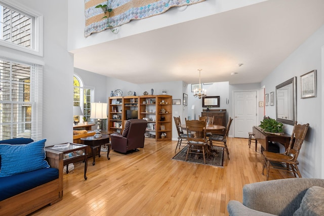 living room with an inviting chandelier and light hardwood / wood-style floors