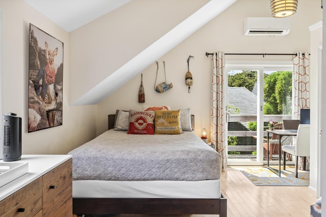 27 Court St Unit U7B, Provincetown, MA 02657 - bedroom featuring a wall mounted air conditioner, wood finished floors, and access to exterior