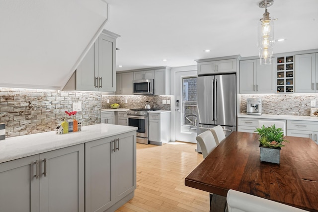 27 Court St Unit U7B, Provincetown, MA 02657 - kitchen featuring stainless steel appliances, tasteful backsplash, gray cabinets, light wood-style flooring, and recessed lighting
