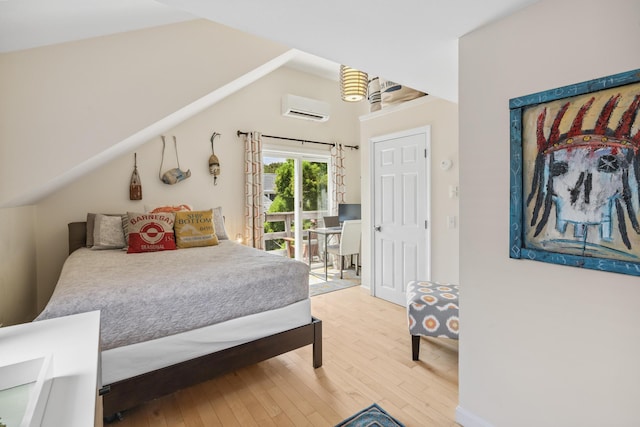 27 Court St Unit U7B, Provincetown, MA 02657 - bedroom featuring a wall mounted AC, hardwood / wood-style flooring, access to exterior, and vaulted ceiling