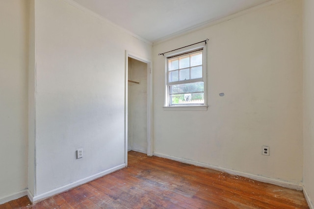 91 Baxter Rd, Hyannis, MA 02601 - unfurnished bedroom with crown molding, wood-type flooring, baseboards, and a closet