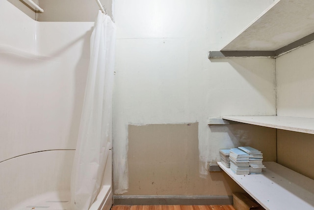 91 Baxter Rd, Hyannis, MA 02601 - bathroom with a shower with shower curtain and wood finished floors