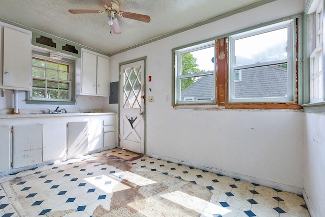 91 Baxter Rd, Hyannis, MA 02601 - kitchen with light flooring, a textured ceiling, light countertops, white cabinetry, and a sink