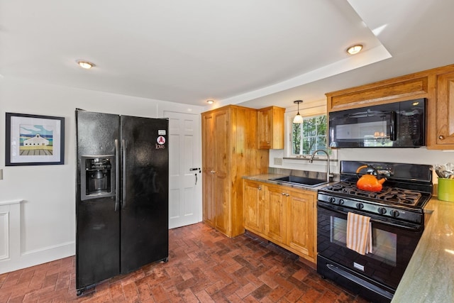 248 Bradford St, Provincetown, MA 02657 - kitchen featuring black appliances, a sink, brick patterned floors, baseboards, and brown cabinets