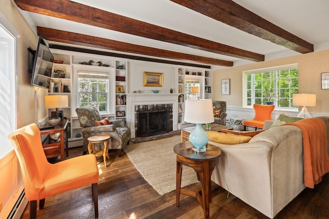 living area with baseboard heating, wood finished floors, a fireplace, and beamed ceiling