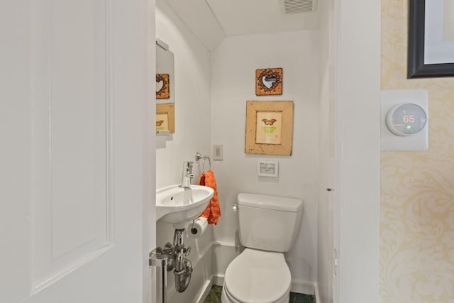 bathroom with baseboards and toilet