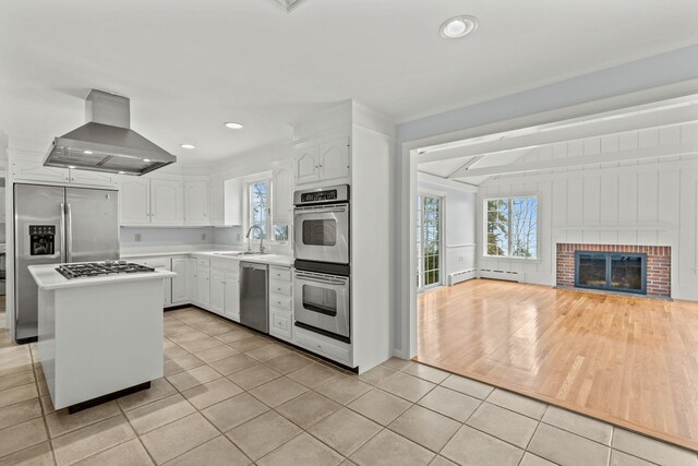 doorway to outside featuring crown molding and light hardwood / wood-style flooring